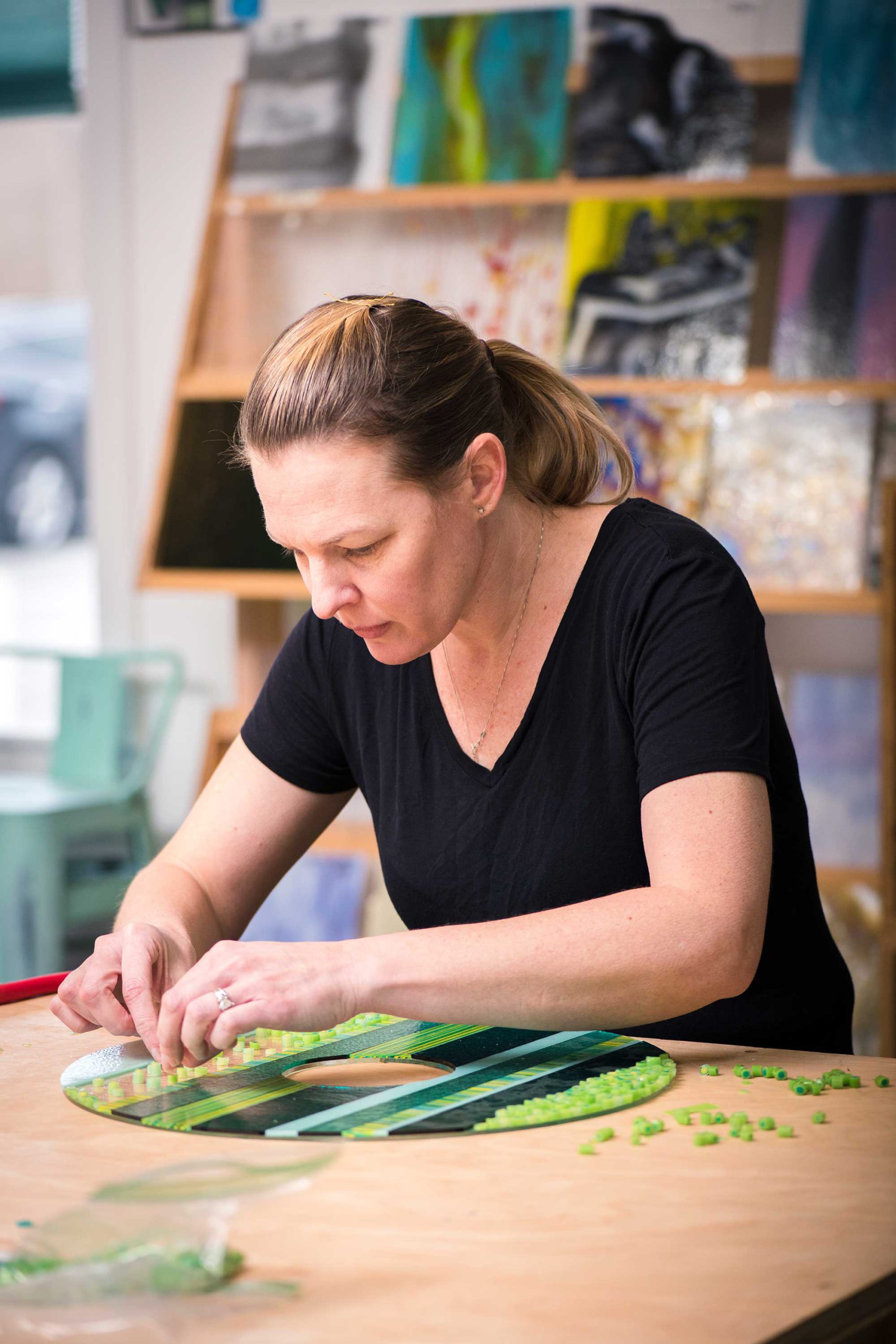 Lisa Becker works on a fused glass piece at her studio Art Glass Array.