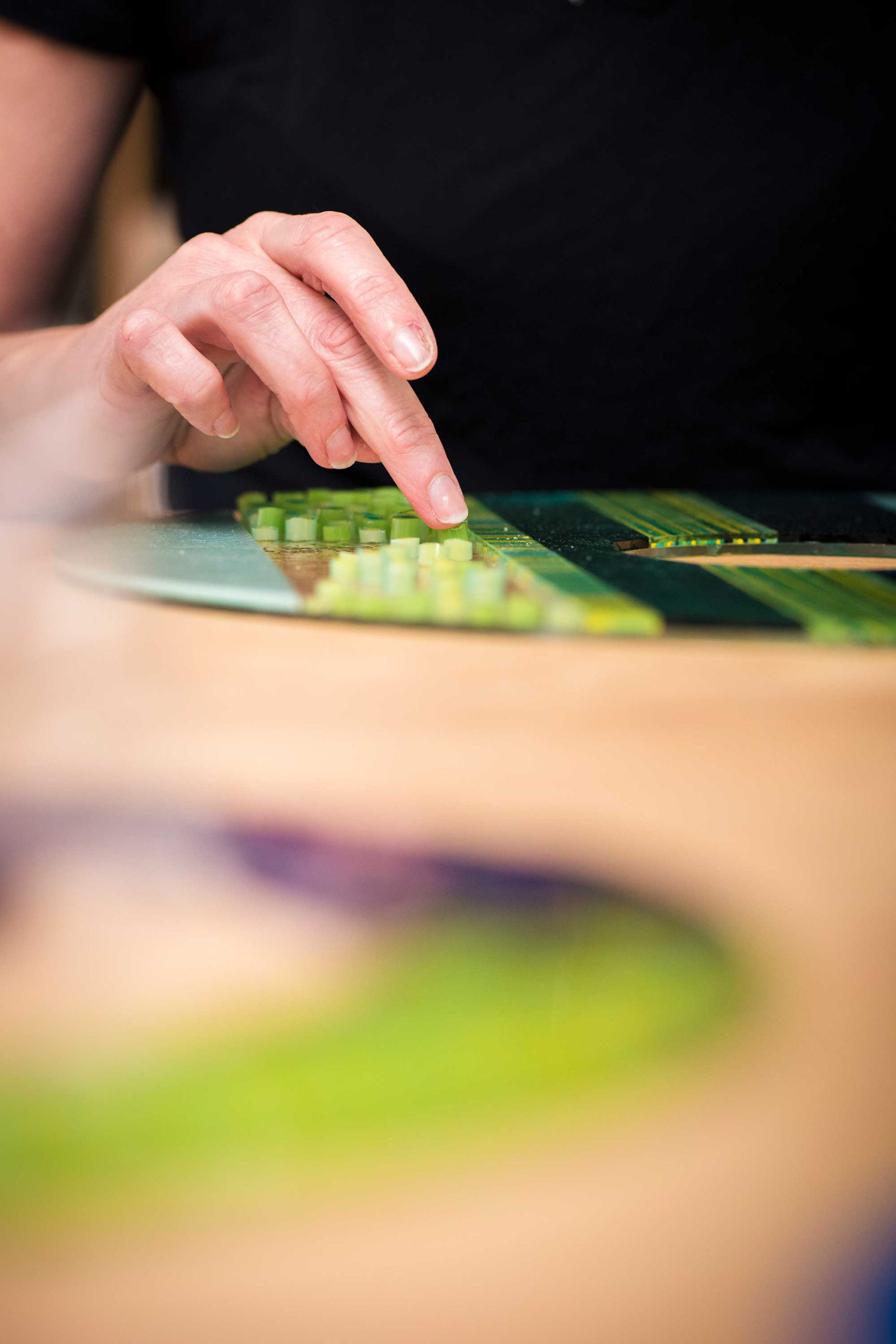 Lisa Becker works on a fused glass piece in her studio Art Glass Array.