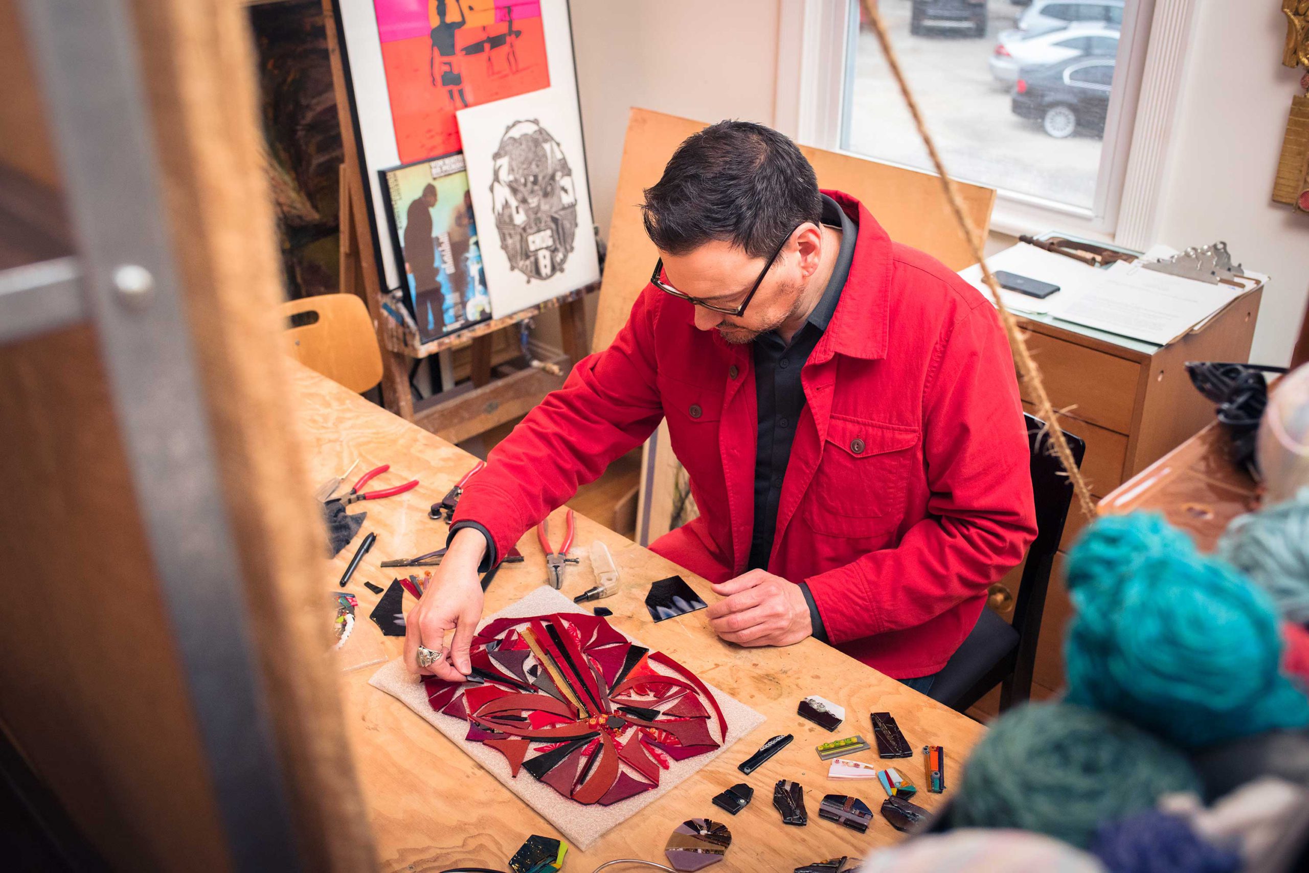 Artist Gregory Dierlam works on a fused glass piece at his gallery Art Meets Vintage.